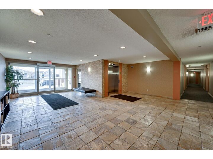 Property Photo:  #215 13830 150 Av NW  AB T6V 1X2 