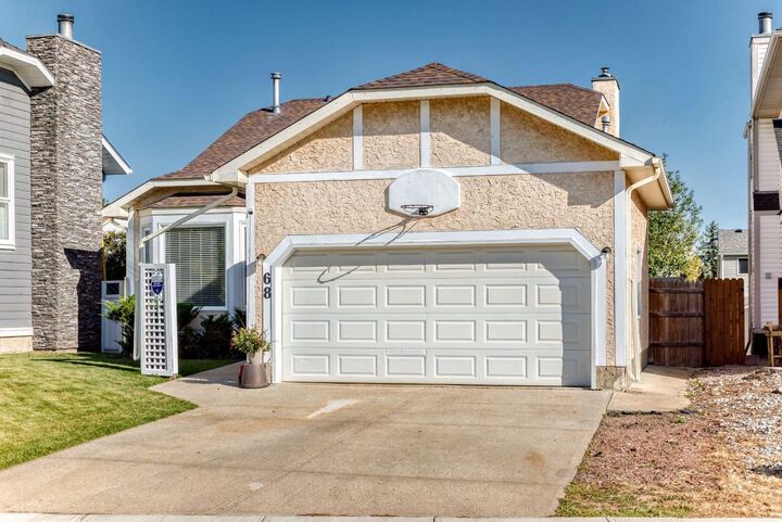 Property Photo: 68 Woodmark Crescent SW AB T2W 4Z2
