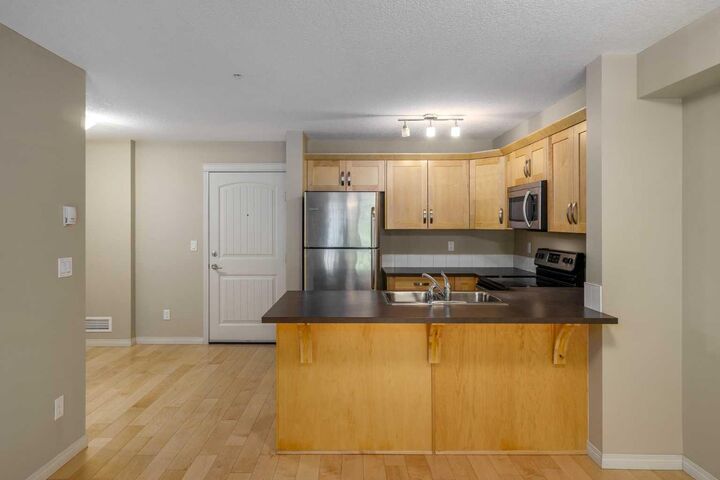 Property Photo:  130 Panatella Street NW 1113  AB T3K 0Y6 