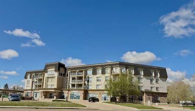 Property Photo: 4425 Heritage Way 406 AB T4L 2P4
